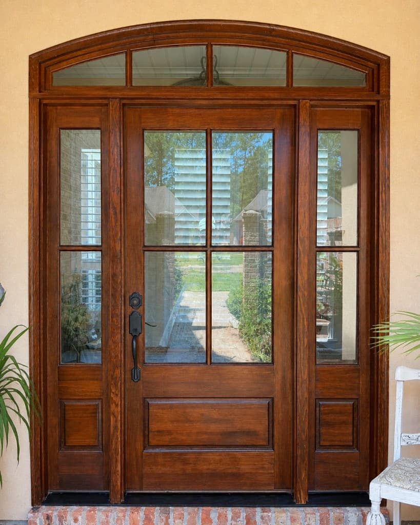 After: professionally refinished front door in Mandeville LA with rich stain and marine-grade varnish protection